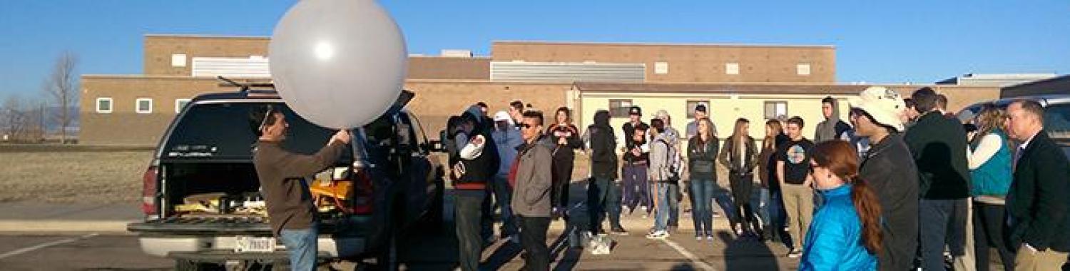 People launching radiosonde at Erie High School