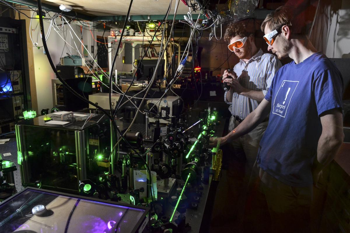 Students using a laser on a laser table