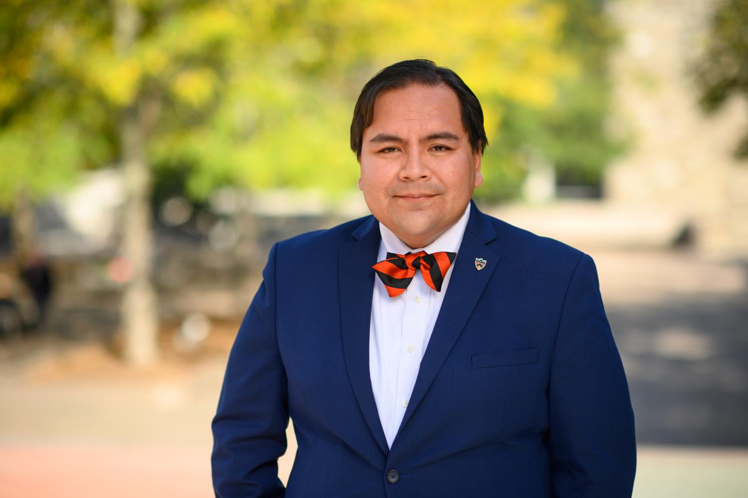 Professor wearing an orange black bowtie.