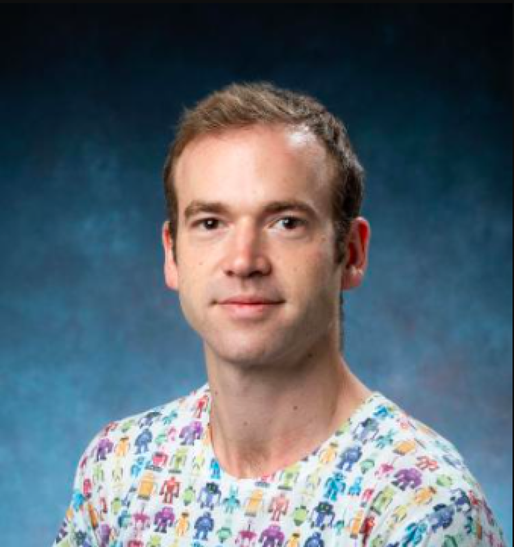 A professional headshot of Yuval Fishler