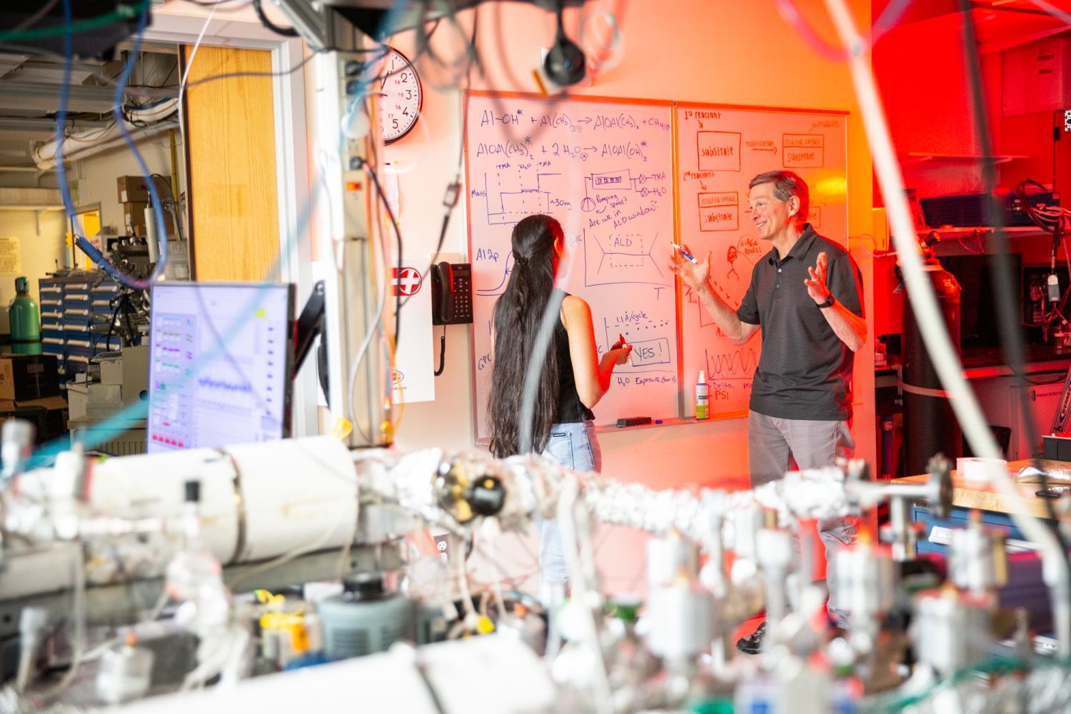 Neha Mahuli & Steve George on the Whiteboard in the Laboratory; University of Colorado at Boulder, Steven M. George Research Group