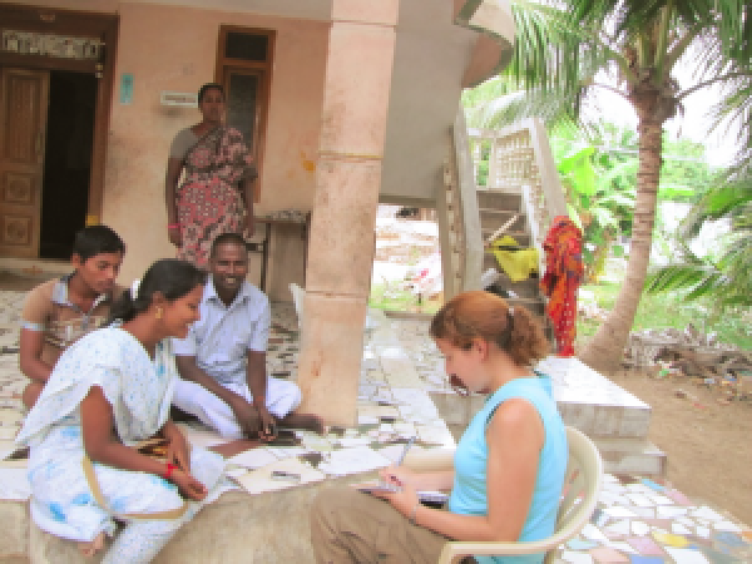 Student conducting interview in Tamil Nadu with households members