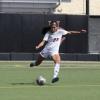 Bobbie kicks a soccer ball in a game