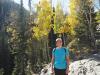 Brittany smiles in front of yellow aspen trees
