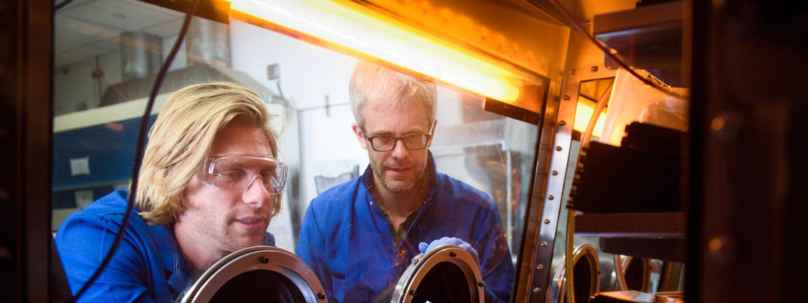 Professor McGehee and Tomas Leijtens conducting research in glove box