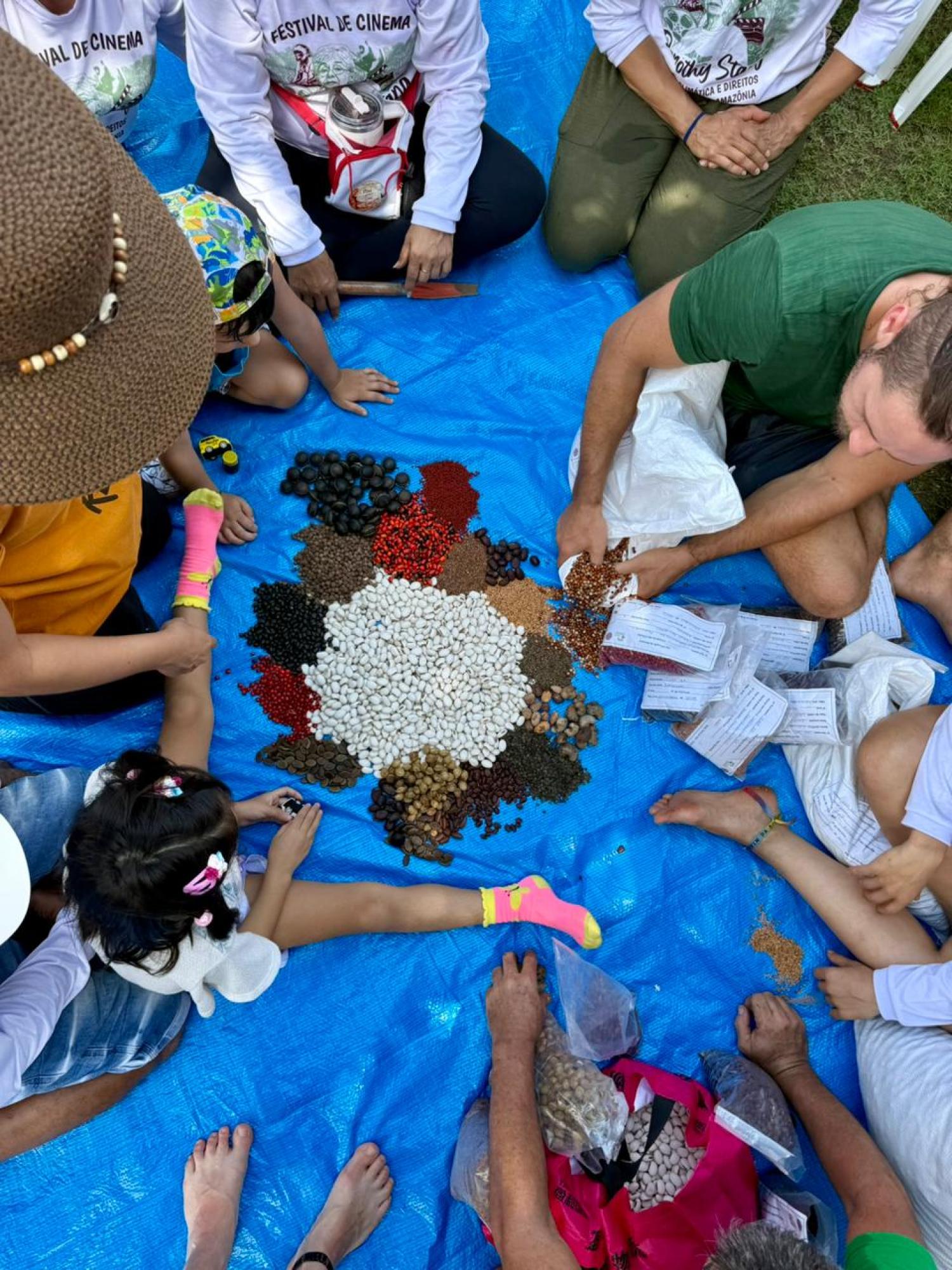 Children and a seed muvuca during an agroecology collective action we joined at Irm&atilde; Dorothy Stang Square, named after the activist who was murdered in Par&aacute; in 2005. PHOTO: Lia Domingues/RSX