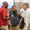 Photograph of three participants at the Local Tech Ecologies conference speaking together