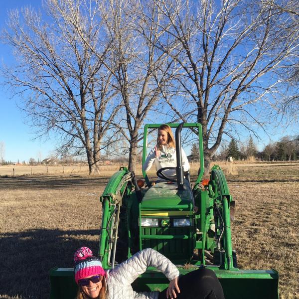 Nicole posing in the tractor bucket