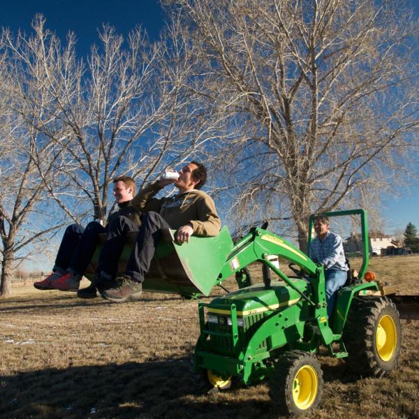 Drinking beer in the tractor bucket