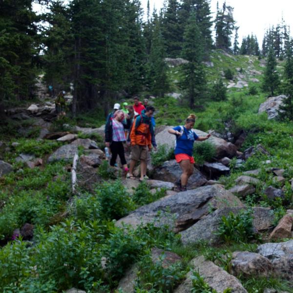 Nicole and lab members crossing the creek