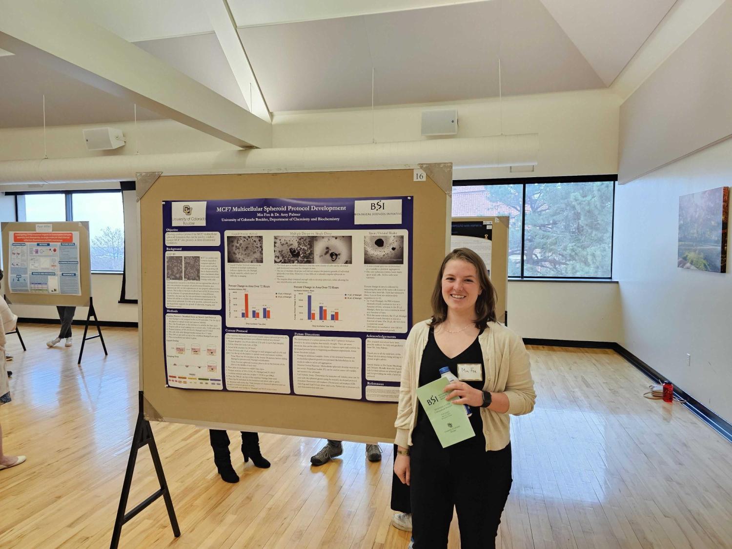 Mia with her poster at the BSI Symposium.