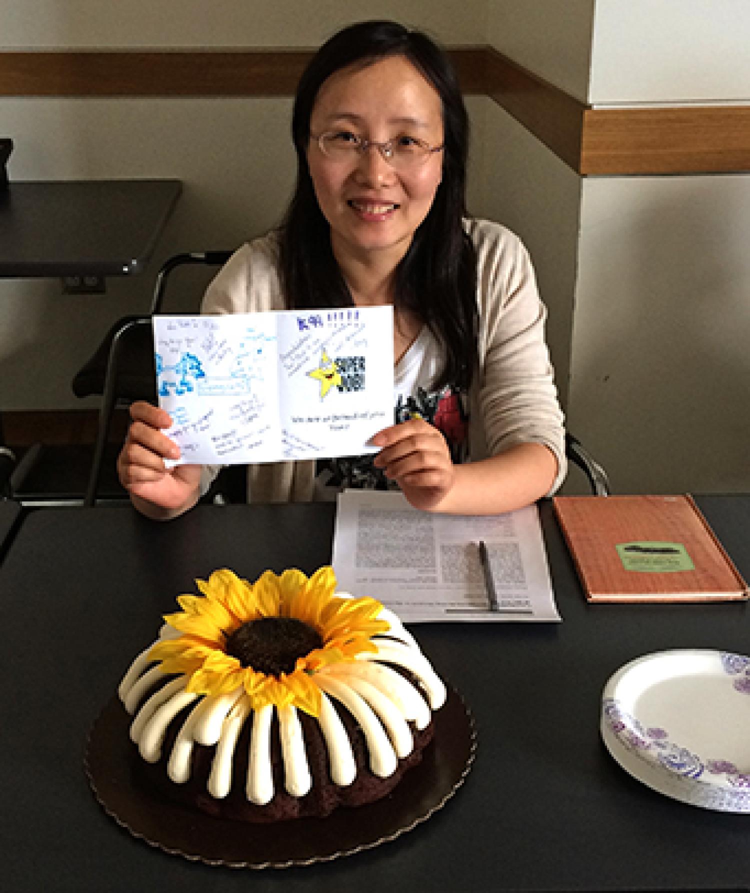 Celebrating Yan with a card and a cake.