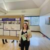 Mia with her poster at the BSI Symposium.
