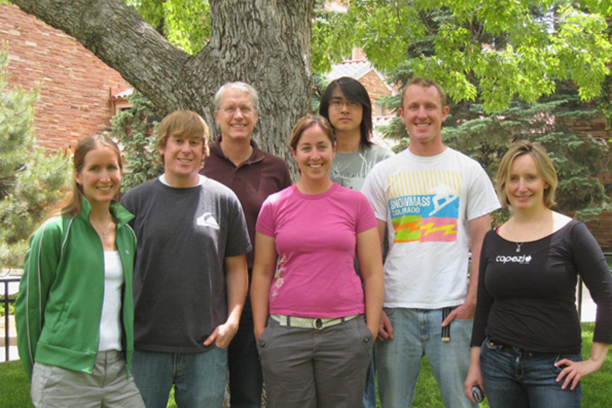 Group posed in front of tree