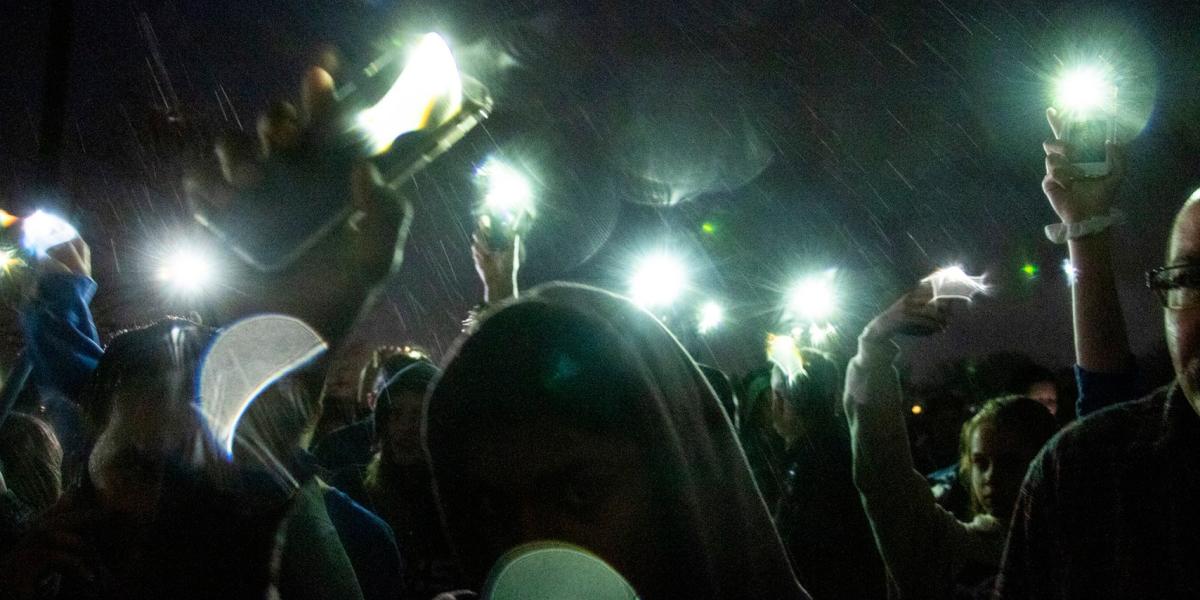 teens holding phones in the air, Kevin J. Beaty - Denverite