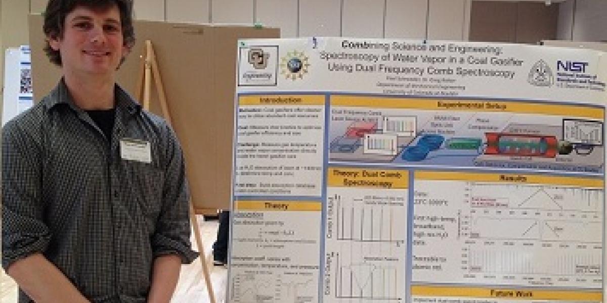 Paul Schroeder with his winning poster at Energy Frontiers