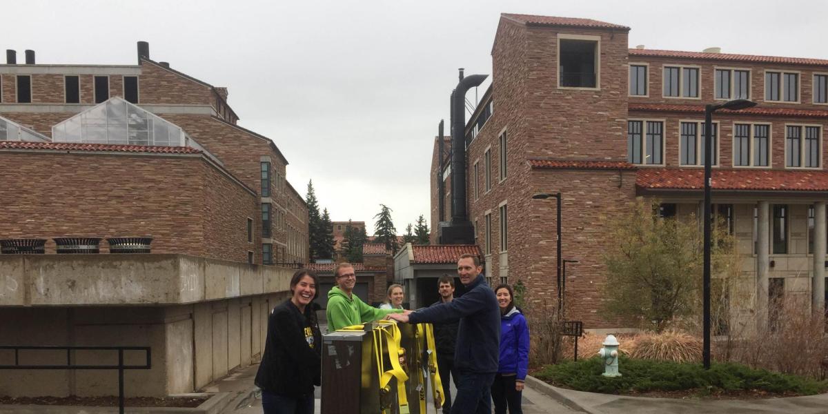 Greg Rieker and his students moving a table through the CU Boulder campus