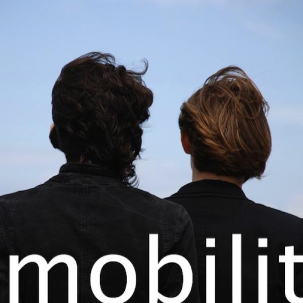 book cover says "mobilit," on an image of the back of 2 male heads.