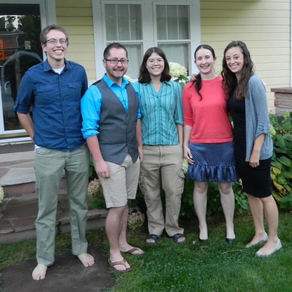 Vaida group members standing outside a house