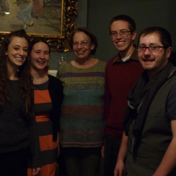 Veronica Vaida standing with group members at the holiday party