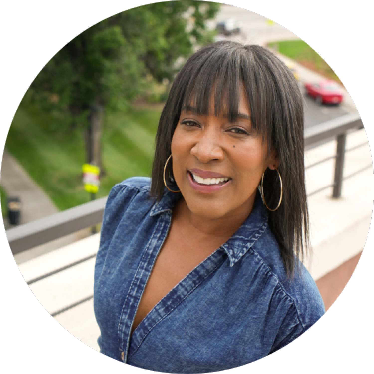 Nandi Pointer poses in front of a fence, smiling for her headshot.