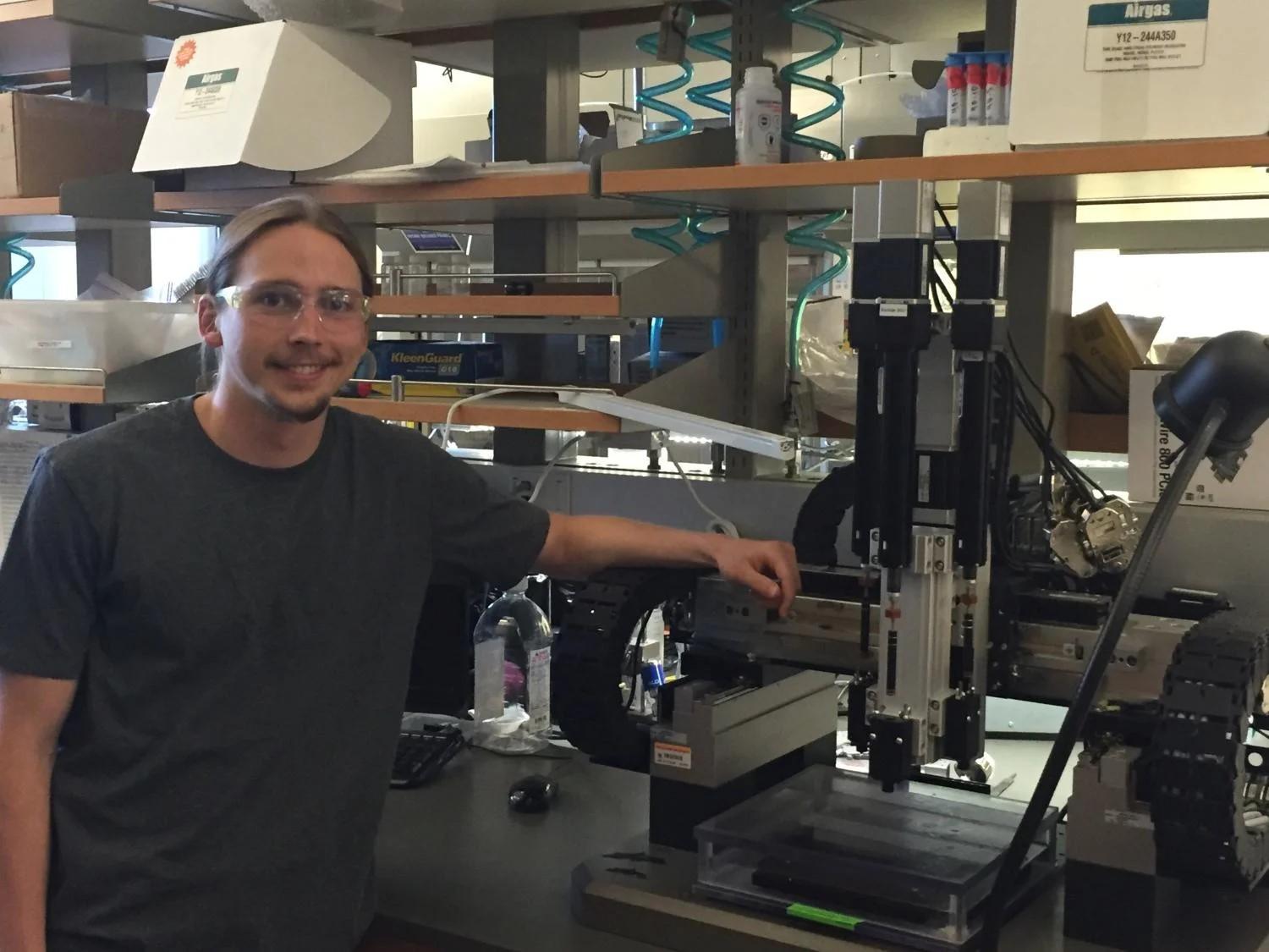 Chris Bartel next to the 3D ceramics printer.