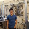 Kevin Sun next to Moses and Dante, the stag flow reactors used for metal oxide water splitting.