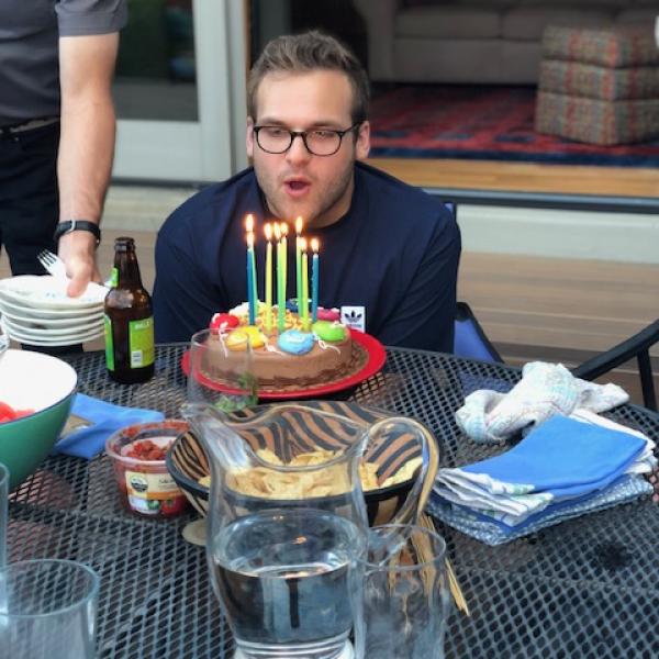 Tom blows out candles