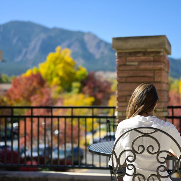 Student reading on outdoor balcony