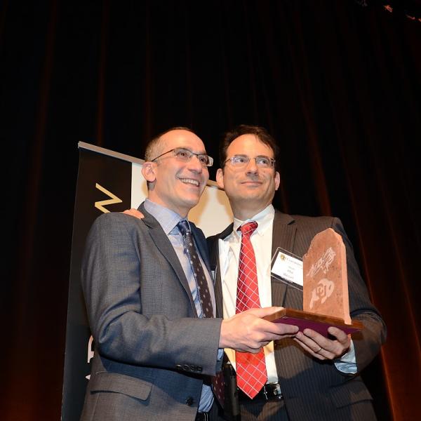 Dean Weiser presenting the Richard Schaden "Adopted Alumni" Award to David Barash on behalf of the Barash family