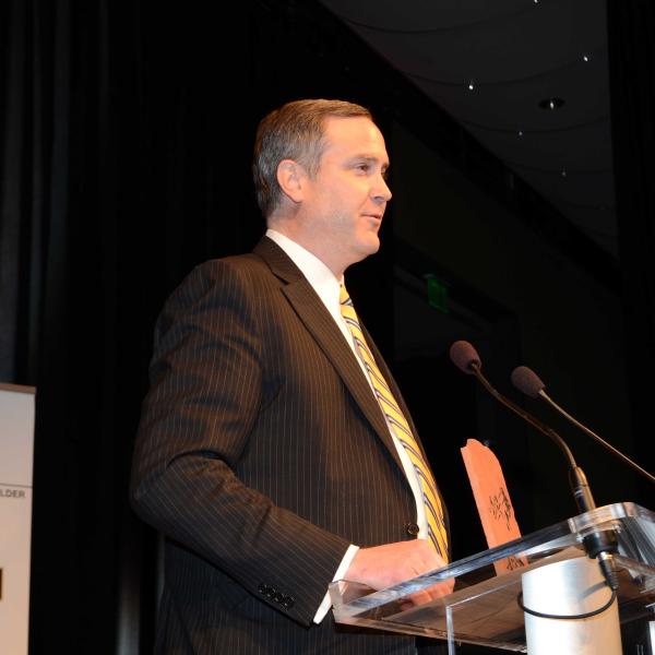 Man with award speaking at banquet