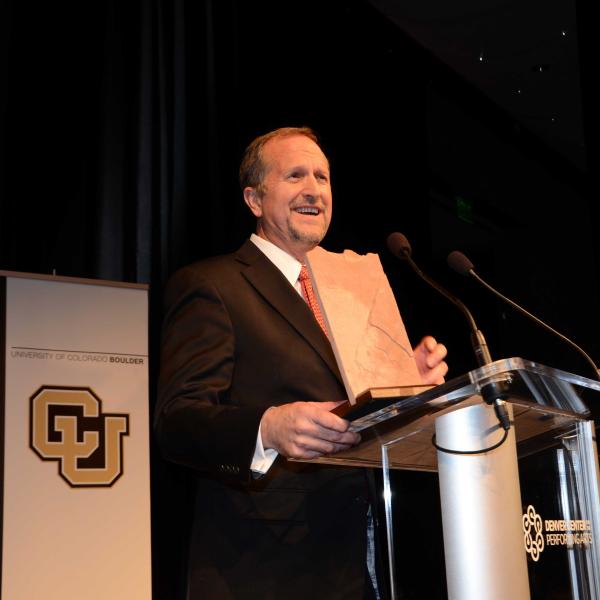 Man with award at podium