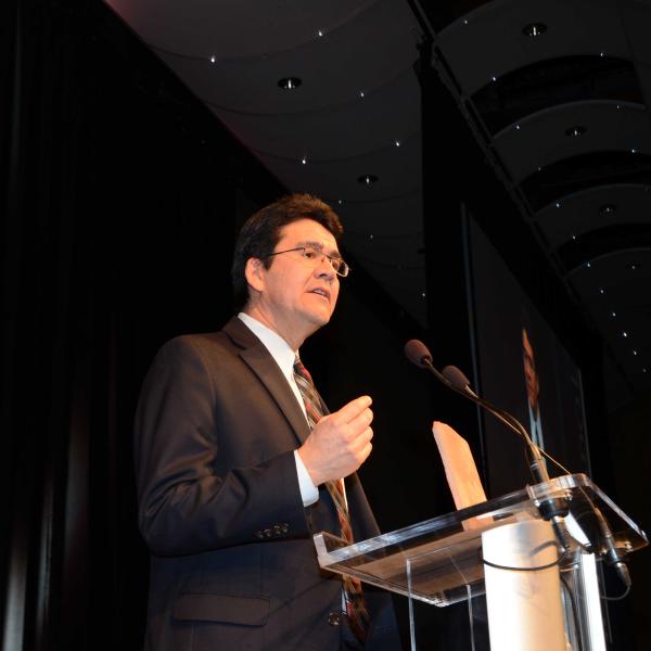 Man speaking at podium at award banquet