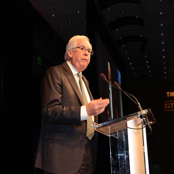 Man speaking at podium during award banquet