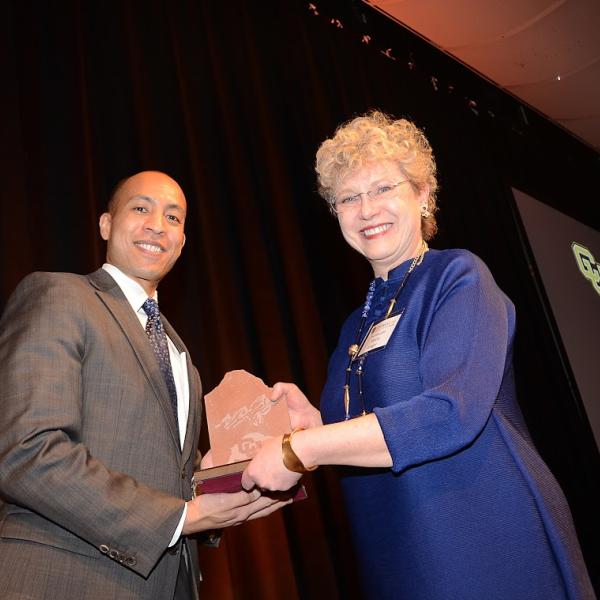 Franz Hardy ('00) presenting the award for Distinguished Achievement - Judiciary to the Honorable Marcia S. Krieger ('79)