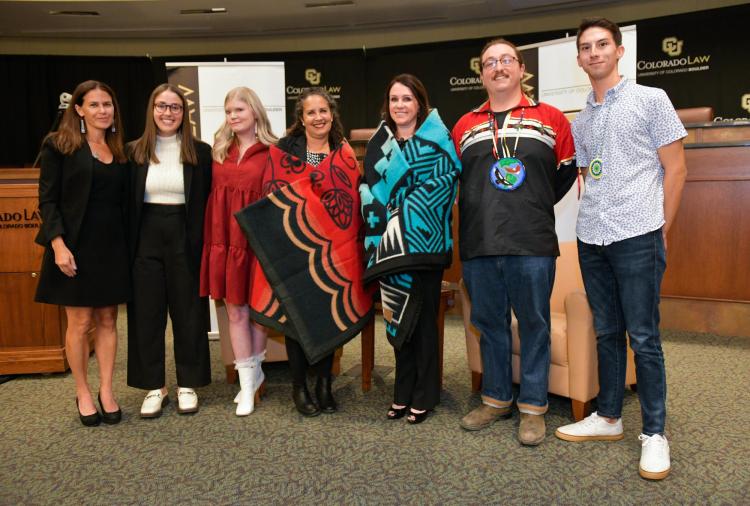 Professor Kristen Carpenter, Director of the American Indian Law Program, and student leaders from NALSA present Chief Justice Riley and Professor Malveaux with gift blankets.