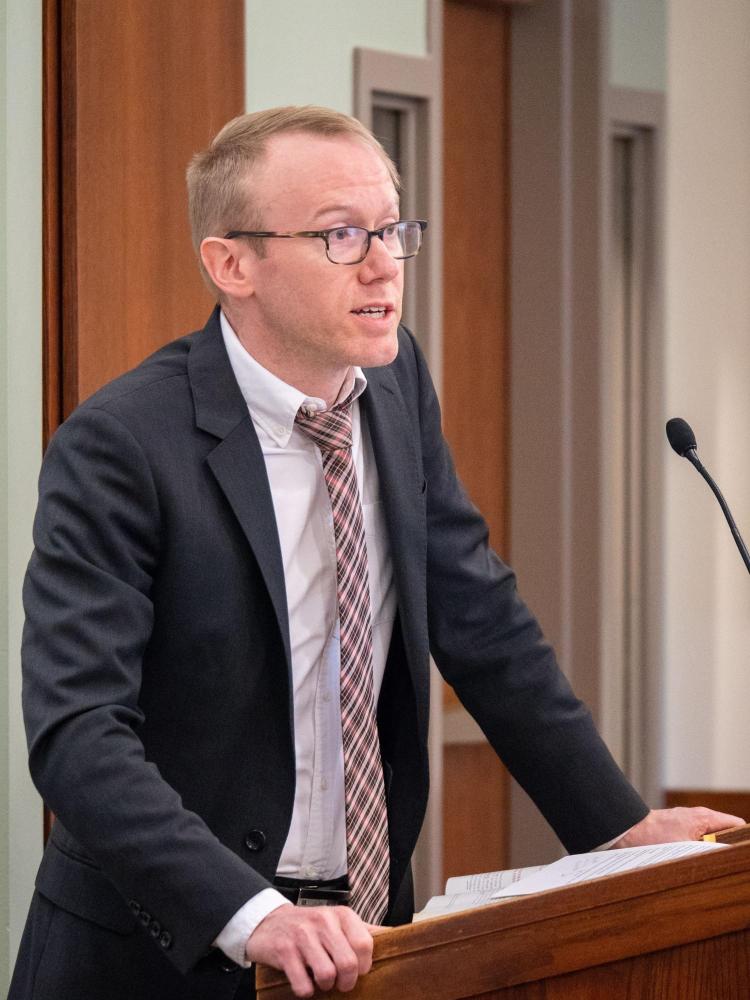 Prof. Scott Skinner-Thompson speaking behind a podium