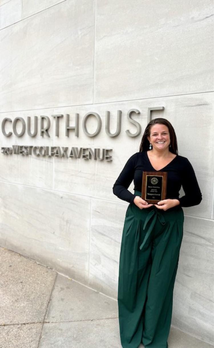 Margaret Farrell stands with her award