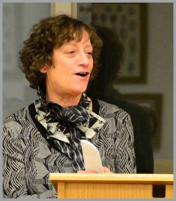 Professor Nevelow Mart presenting behind a wooden lectern