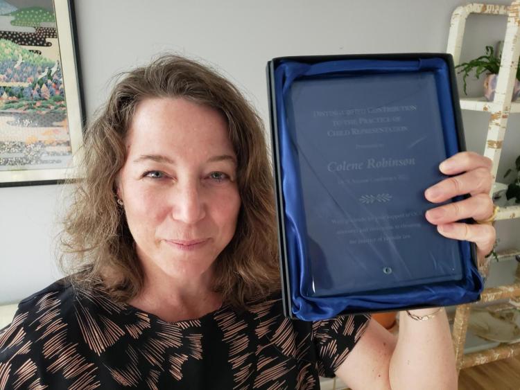 Professor Robinson holds up the OCR award