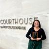 Margaret Farrell stands holding her award