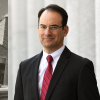 headshot of AG Weiser on graphic background