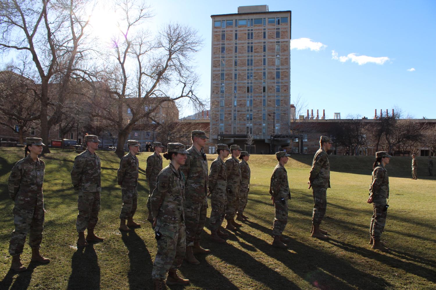 Air Force ROTC cadets stand at attention in uniform