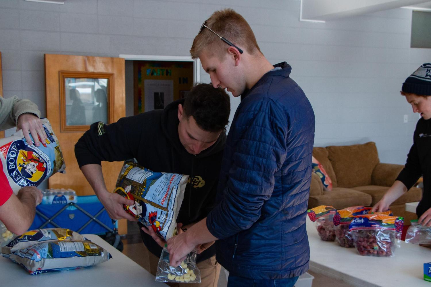 Leading EDGE students filling bags of food for the Boulder unhoused