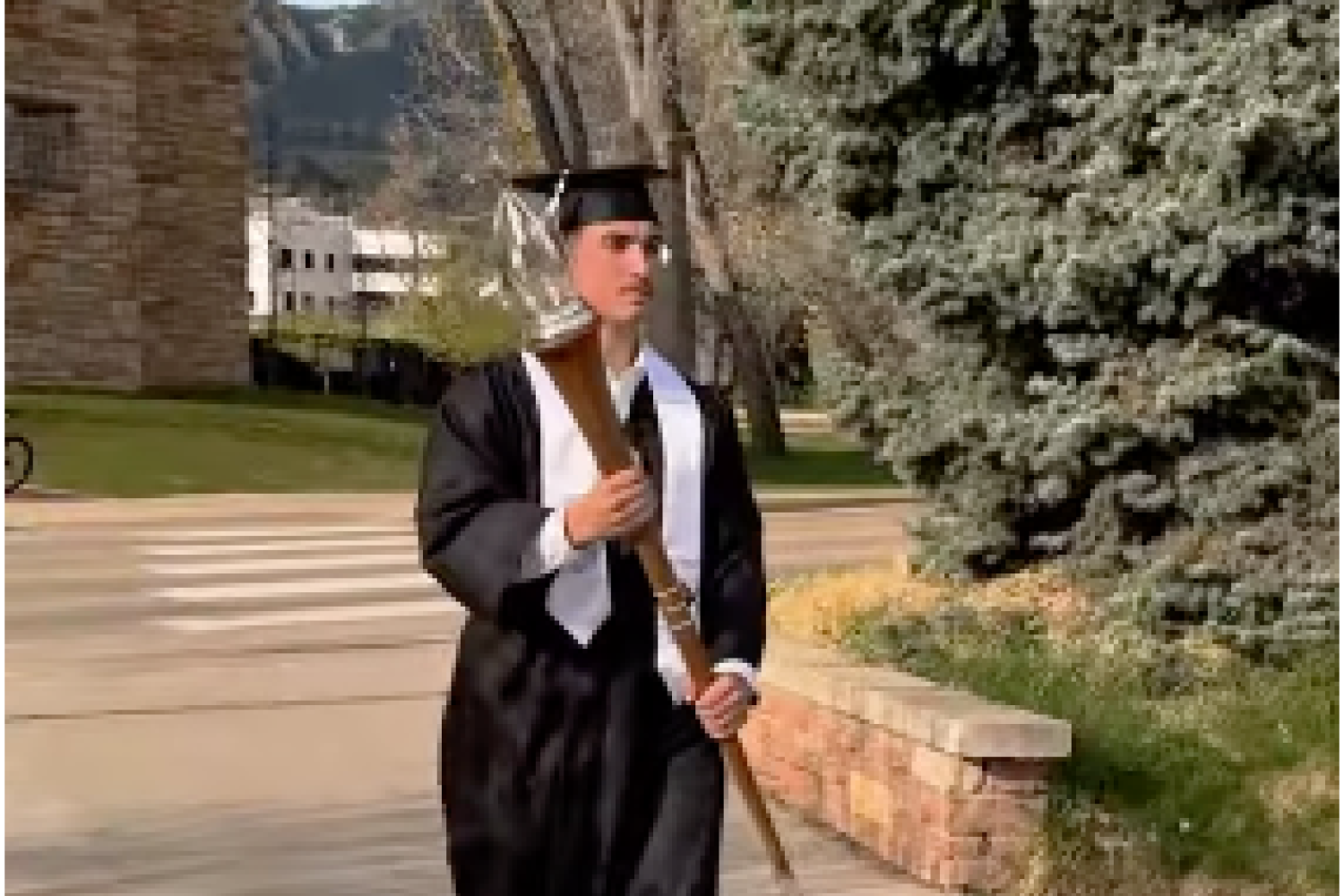 CFL Student holding mace in CU Boulder Commencement Ceremony