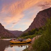 River raft in a canyon at sunset