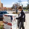 Person voting at voting box near the UMC