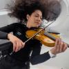 Sarah Gillis playing violin in space