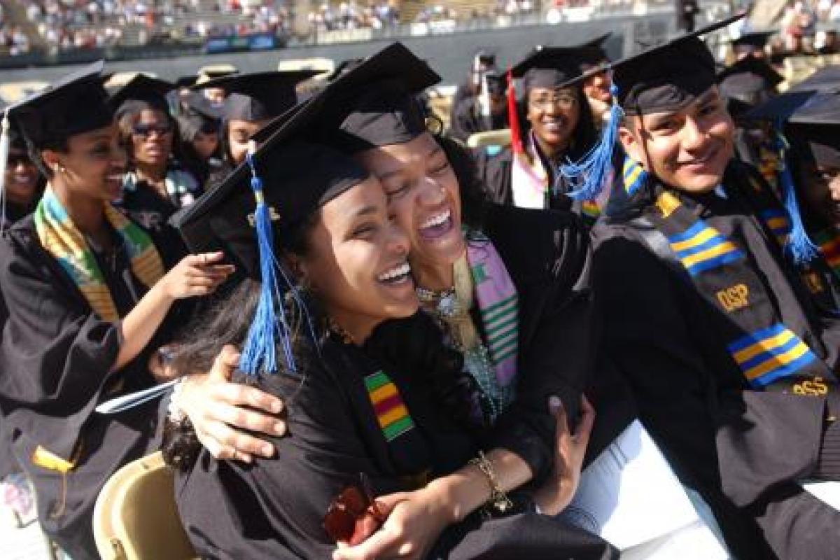 LEAD Alliance students hugging and laughing during their commencement ceremony