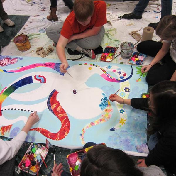 students collaborate to paint an octopus mural